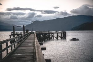 A dock over a body of water is captured with an ominous feeling. This symbolizes the isolation an individual can feel before beginning Christian counseling in Atlanta, GA with Faith and Family Empowerment.