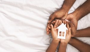 A close up of a family holding a paper house in their hands. This could represent the support marriage counseling in Decatur, GA can offer. Contact a marriage counselor in Norcross, GA to learn more about Christian marriage counseling in Decatur, GA. 30030