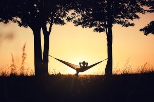 A person sits in a hammock against the setting sun. This could represnt self care that anxiety treatment in Decautr, GA can encourage. Learn more about anxiety therapy in Atlanta, GA today by contacting an anxiety therapist in Atlanta, GA. 30030