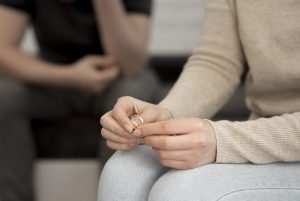 A close up of a woman holding her wedding ring in her hand. This could represent the concerns of infidelity that affair recovery in Atlanta, GA can address. Learn more about affair recovery in Decatur, GA and other services by contacting an online therapist in Atlanta, GA today.