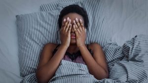 Shows a woman in bed tired. Represents how depression counselor in atlanta, ga could help you realize depression can affect your sleep.