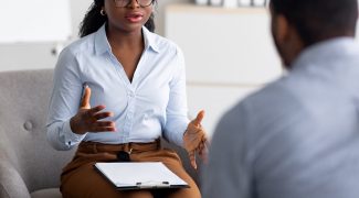 Shows a therapist talking to a client. Symbolizes how relationship therapy for singles in atlanta, ga will support you learning skills to benefit you in your relationships.