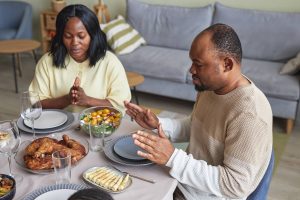 Shows a couple eating dinner. Represents how couples therapist in atlanta, ga can support empty nesters. Search for |black marriage counseling today!