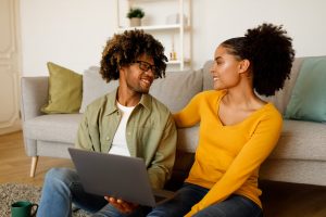 Shows a black couple on the computer. Represents how black marriage counseling will support black or interracial couples to work through challenges. Search for "couples therapist in atlanta, ga" to receive support!