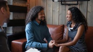 Shows a couple in black marriage counseling. Represents how working with a couples therapist in atlanta, ga can be available through online therapy in georgia.