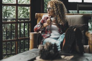 Shows a woman looking outside. Represents how a couples therapist in atlanta, ga will help you navigate the grief in online therapy in georgia.