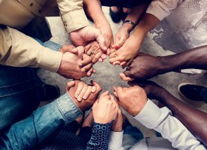 Shows a group holding hands. Symbolizes how pastoral counseling in atlanta, ga can support you. Search a "black christian therapist atlanta" today!