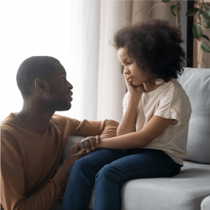 Shows a father talking to his child like he learned in christian counseling in atlanta, ga. Represents how a black therapist decatur ga can understand you and your religion.