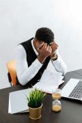 A man overwhelmed with stress at his desk, representing the emotional weight EMDR therapy in Atlanta can help lift with the support of an EMDR therapist in Atlanta.