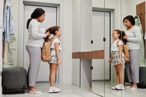 A mother fixes her daughter's hair before school, representing the daily parenting demands that a marriage counselor decatur ga and christian counseling atlanta can help couples navigate.